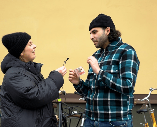 woman-interviewing-man-real-money-film-still-shot